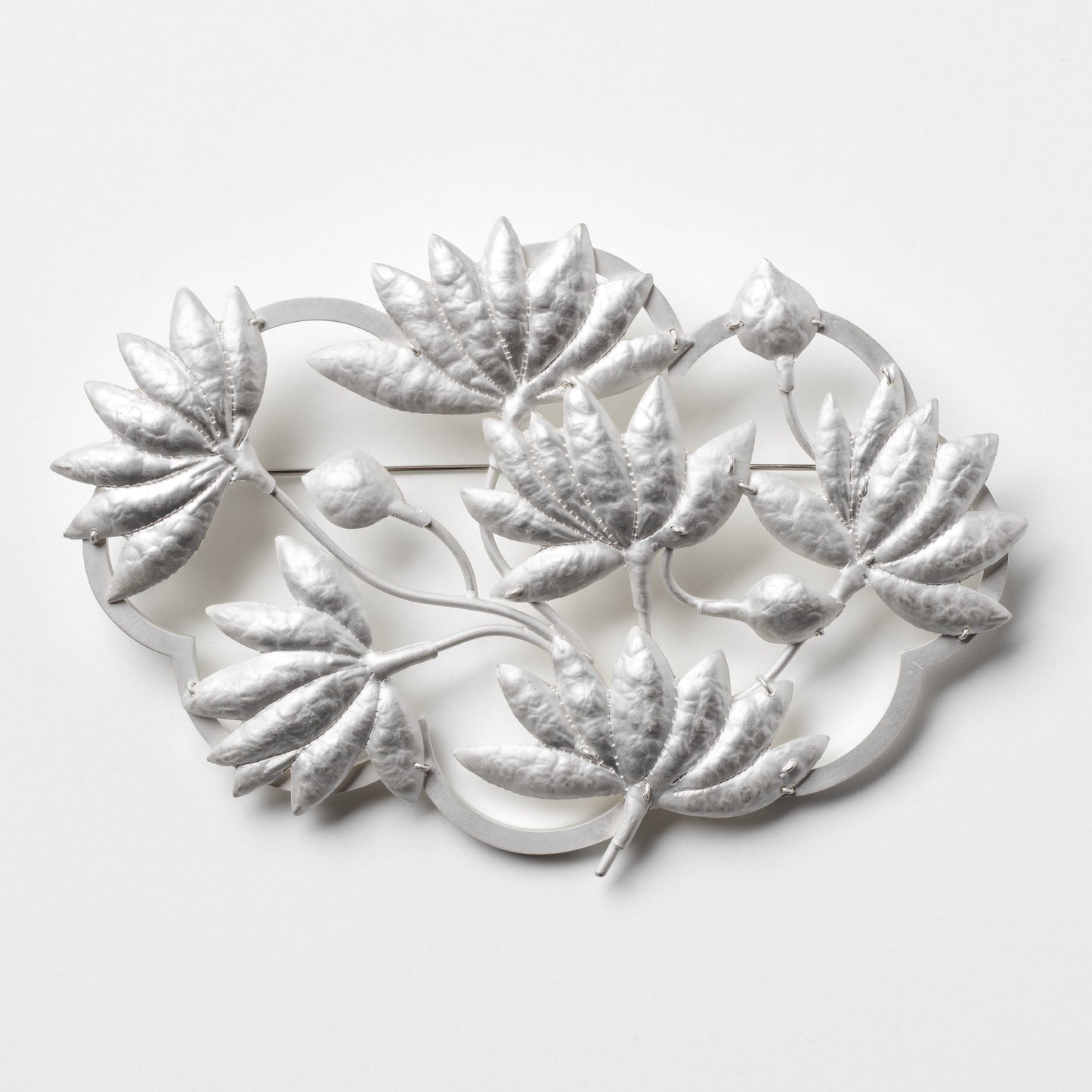 Decorative metal wall art with leaf designs on a white background