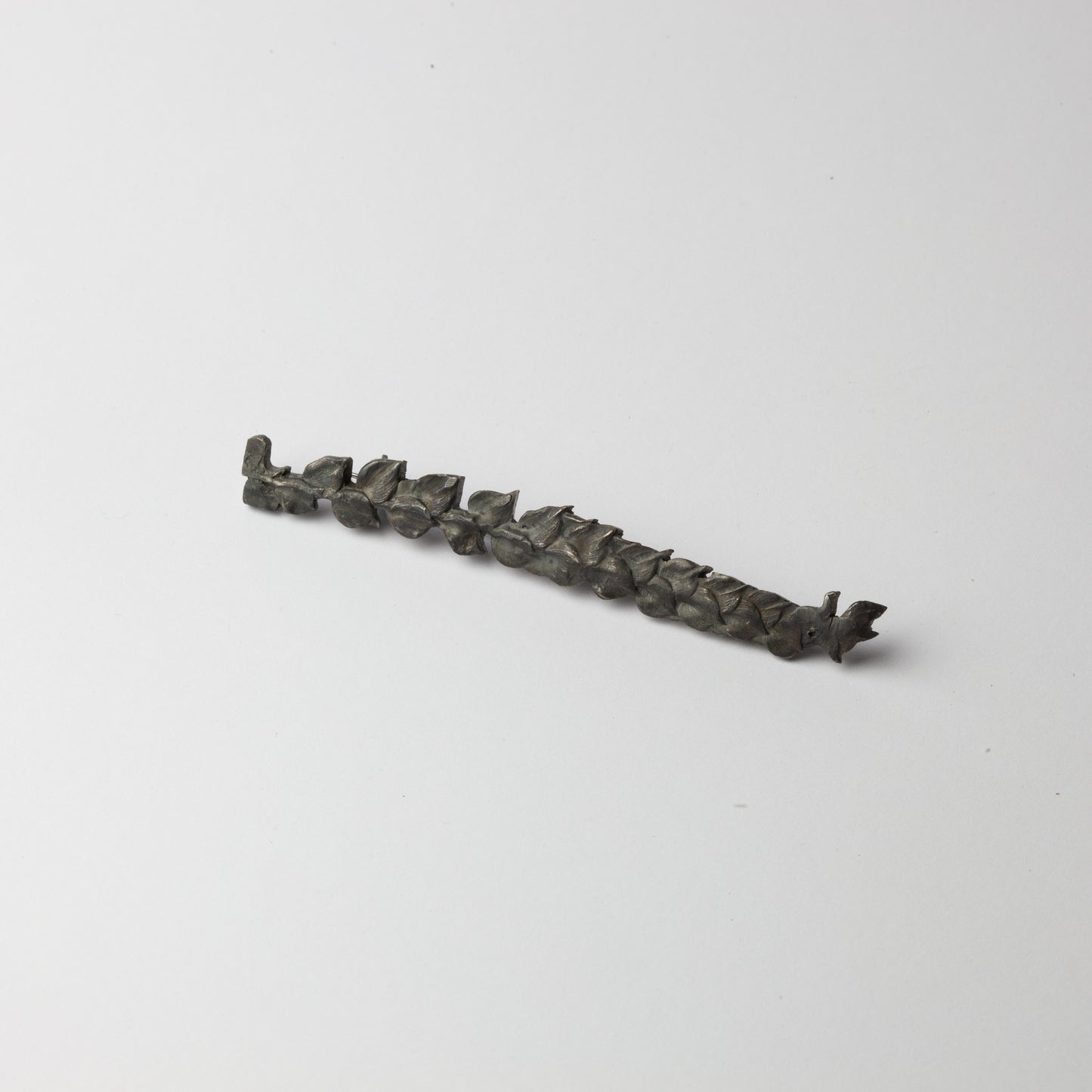 Long black leaf brooch