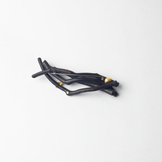 'Burnt stick with gold leaves' brooch