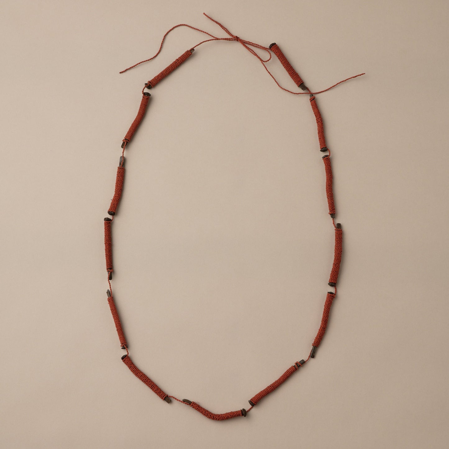 Necklace with red beads on a beige background