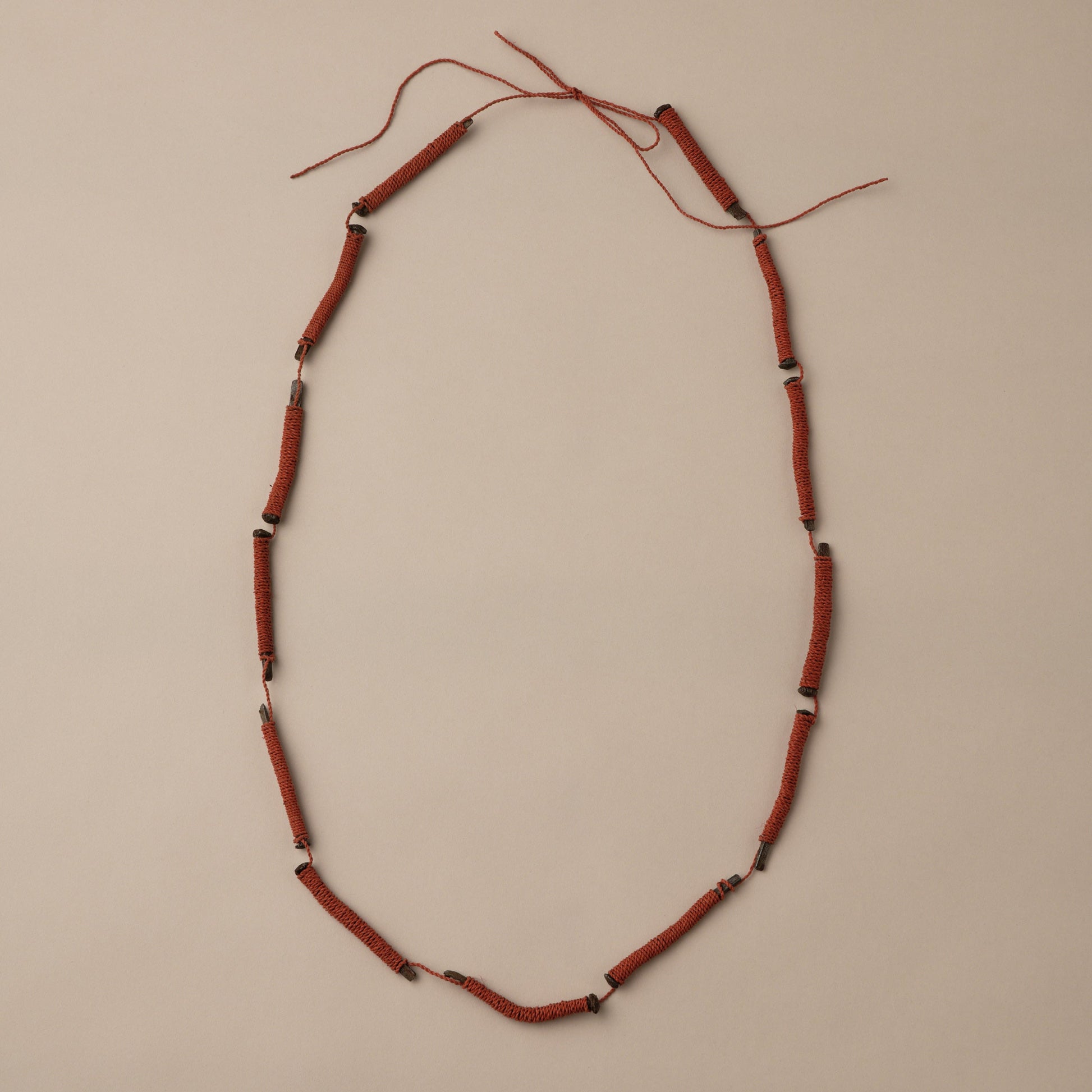 Necklace with red beads on a beige background