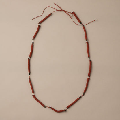 Necklace with red beads on a beige background