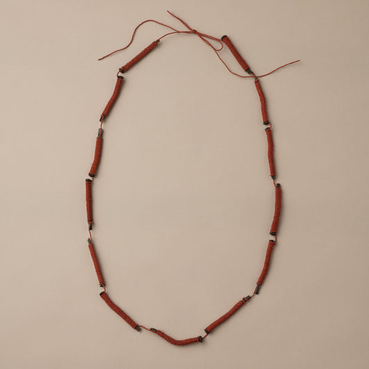 Necklace with red beads on a beige background