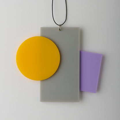 Necklace with a rectangular pendant featuring a yellow circle and purple rectangle on a white background