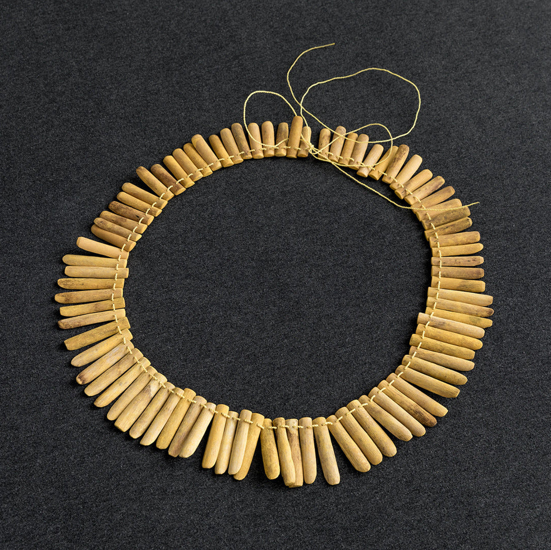 Beaded circular necklace on a dark background