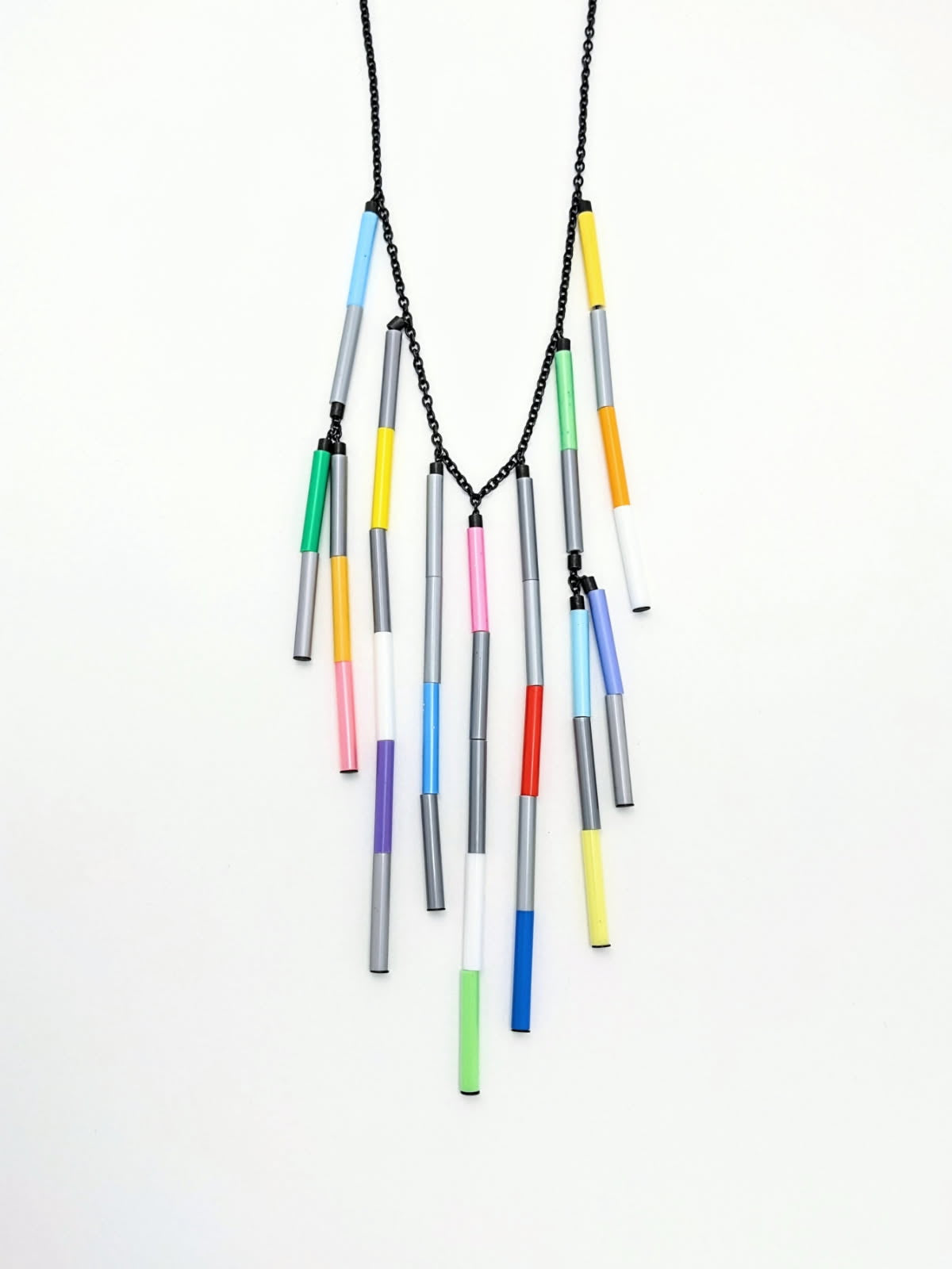 Necklace with colorful cylindrical beads on a white background