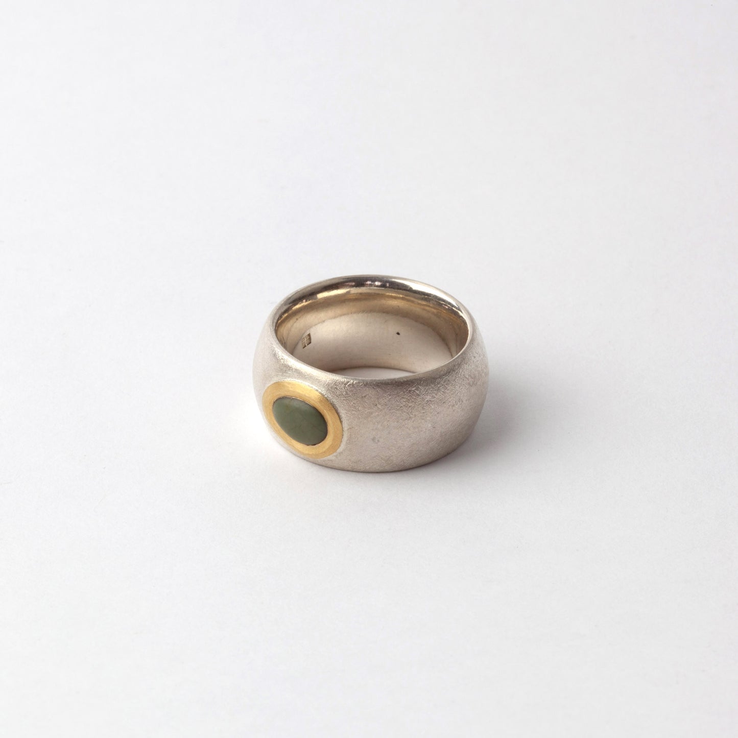 Silver ring with green pebble