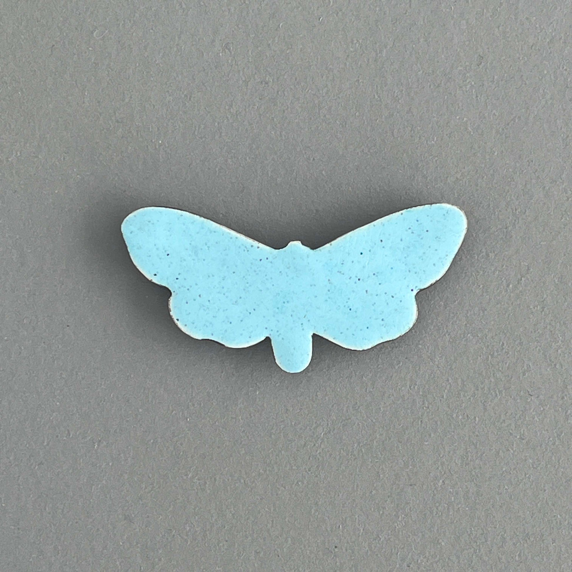 Light blue butterfly-shaped object on a gray background