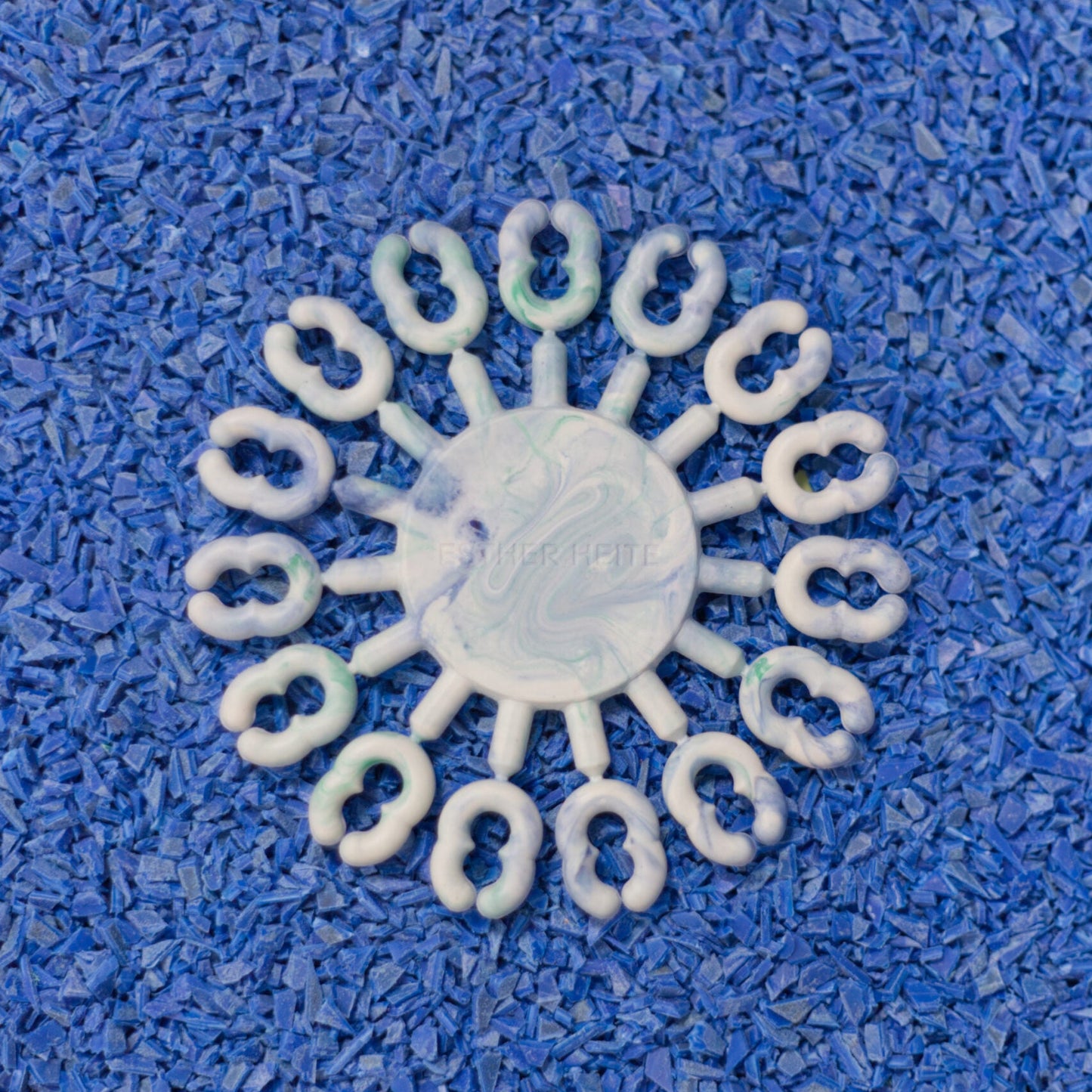 White circular object with a textured surface on a blue textured background