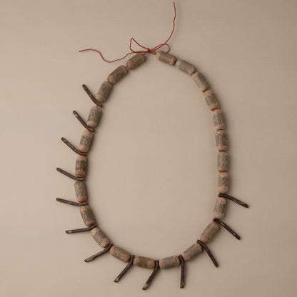 Decorative wreath made of sticks and twigs on a beige wall