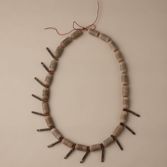 Decorative wreath made of sticks and twigs on a beige wall