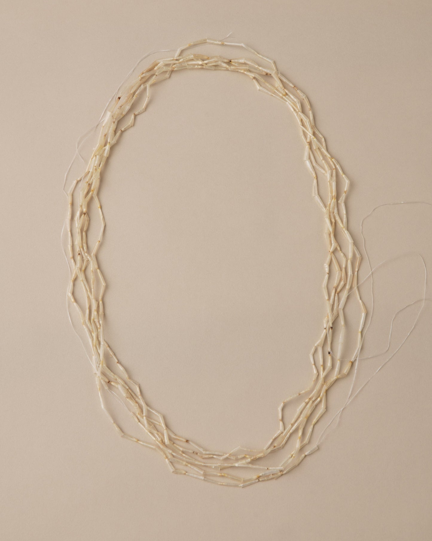 Necklace with multiple strands on a beige background