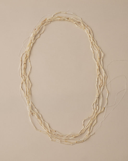 Necklace with multiple strands on a beige background