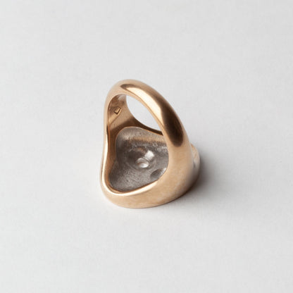 Gold ring on a light gray background