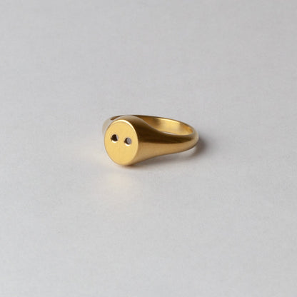Gold ring on a light gray background