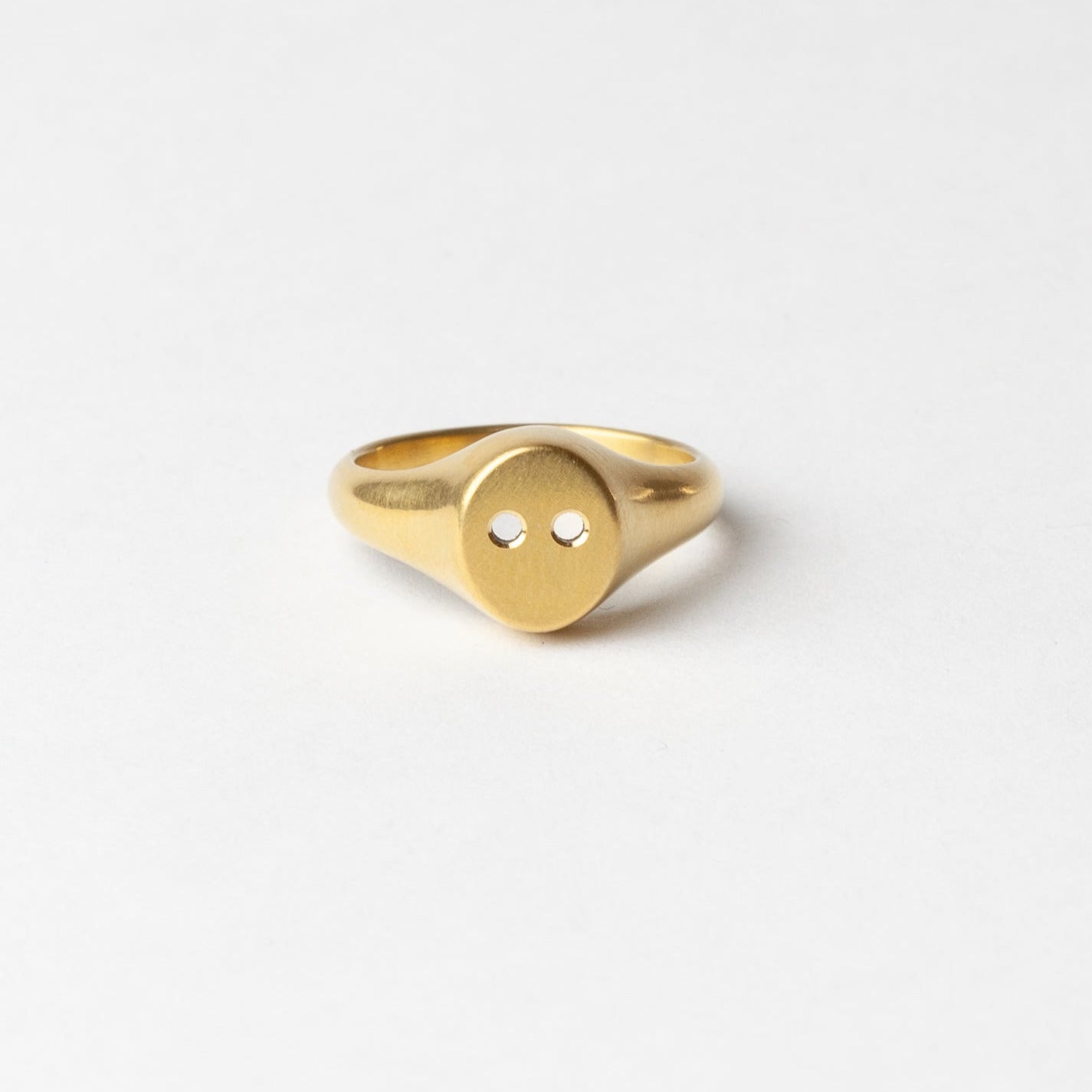 Gold ring with a unique design on a white background