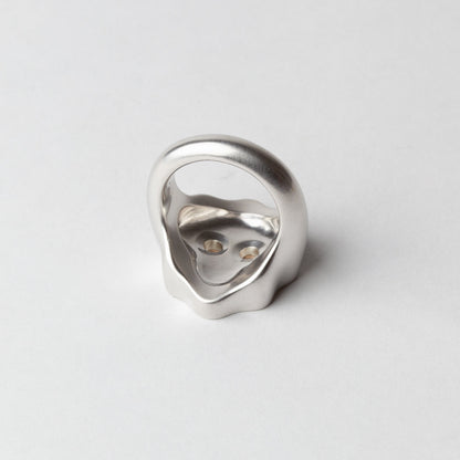 Silver ring with a unique design on a light gray background