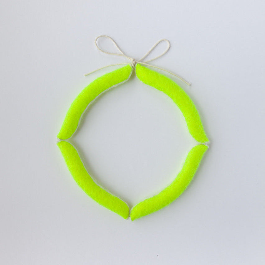 Neon green circular object on a light gray background