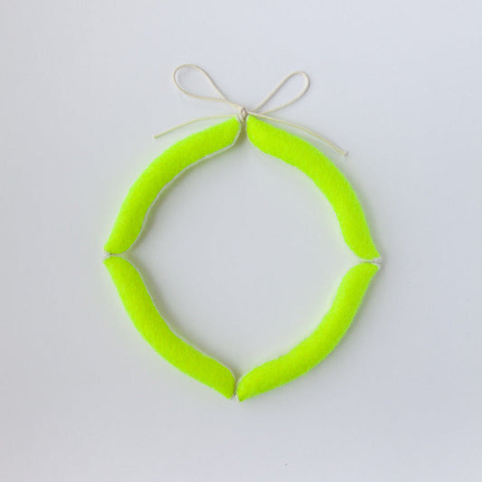 Neon green circular object on a light gray background