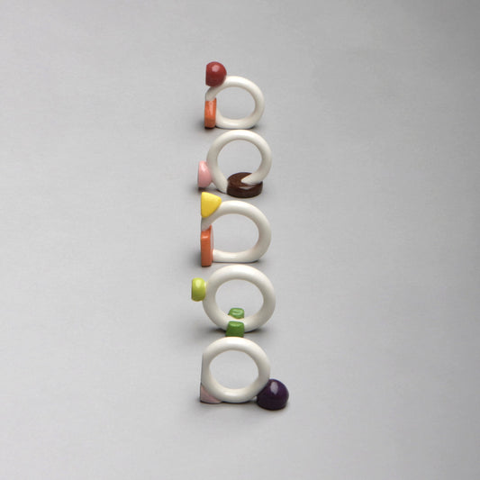 Set of colorful ceramic rings on a gray background