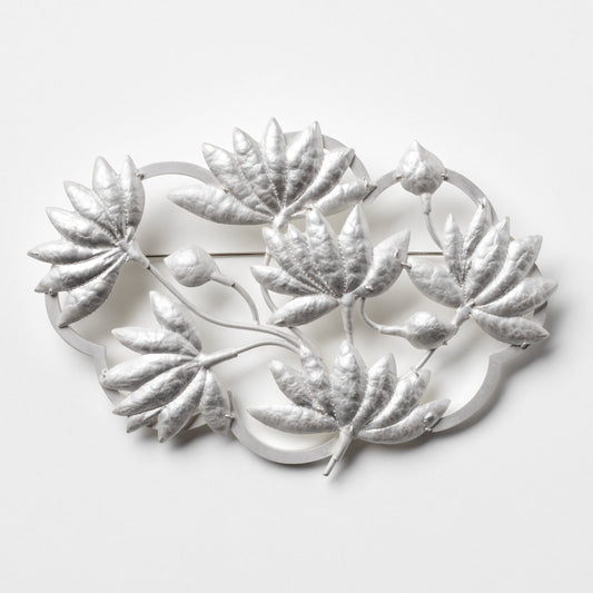 Decorative metal wall art with leaf designs on a white background