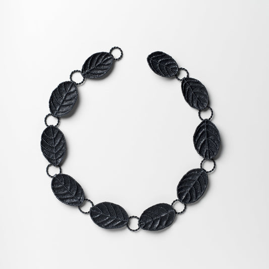 Black leaf-shaped necklace on a white background
