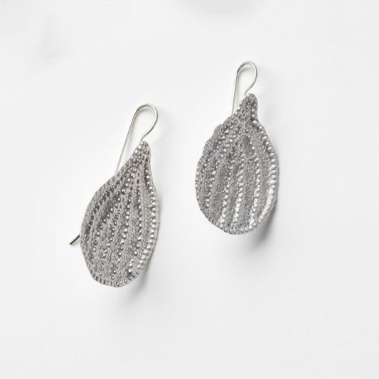 Pair of silver leaf-shaped earrings on a white background