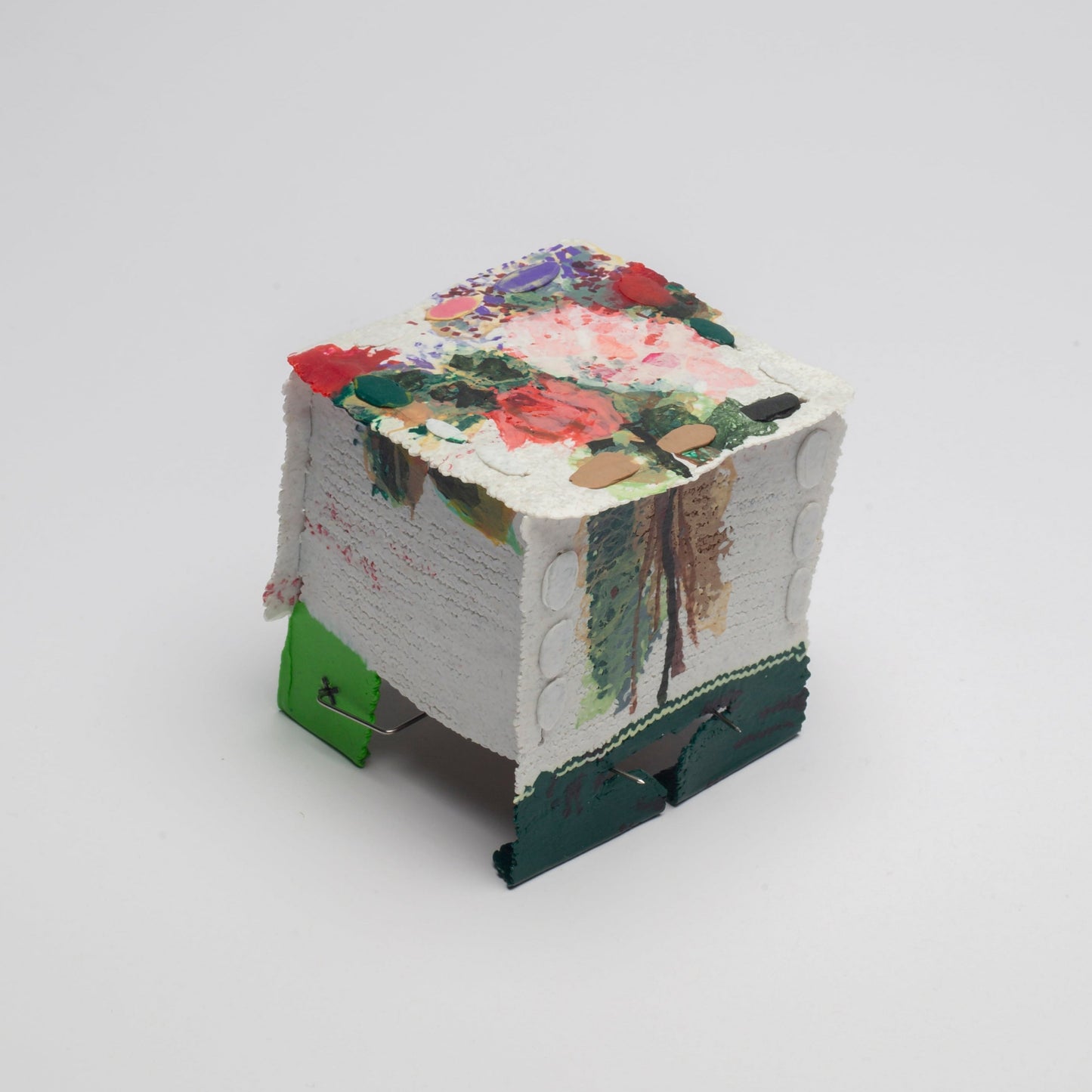 Small decorative box with floral design on a white background