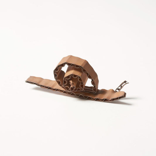 Brown snail brooch on a white background
