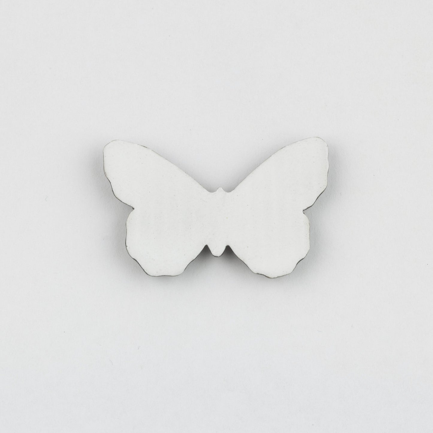 White butterfly-shaped object on a light gray background