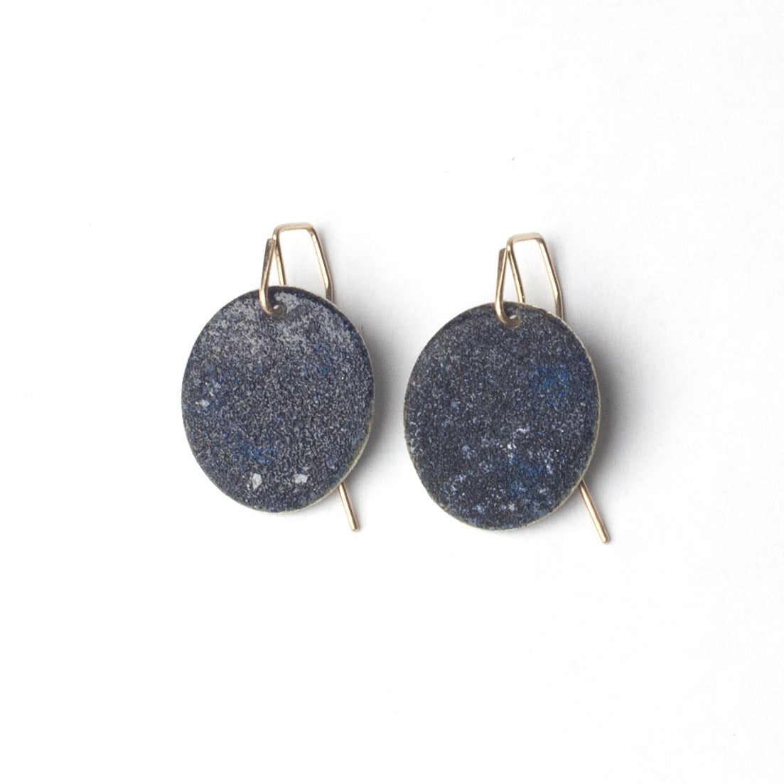 Blue black enamel earrings with gold hooks on a white background
