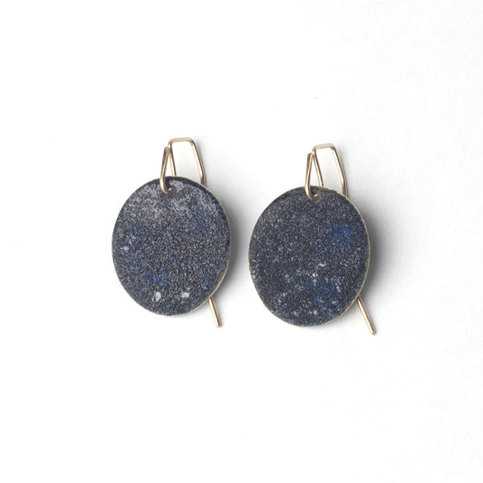 Blue black enamel earrings with gold hooks on a white background