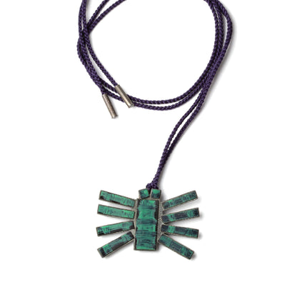 Necklace with a green stone pendant on a white background