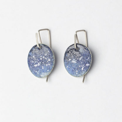 Pair of blue speckled earrings on a white background