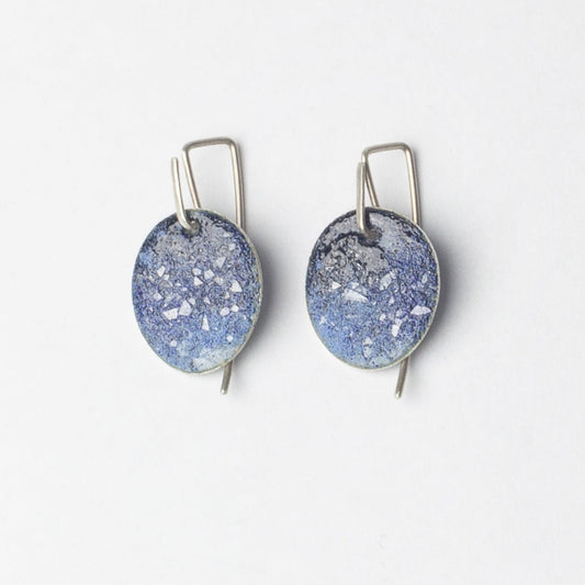 Pair of blue speckled earrings on a white background