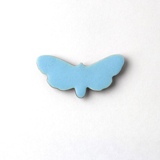 Blue butterfly-shaped object on a white background