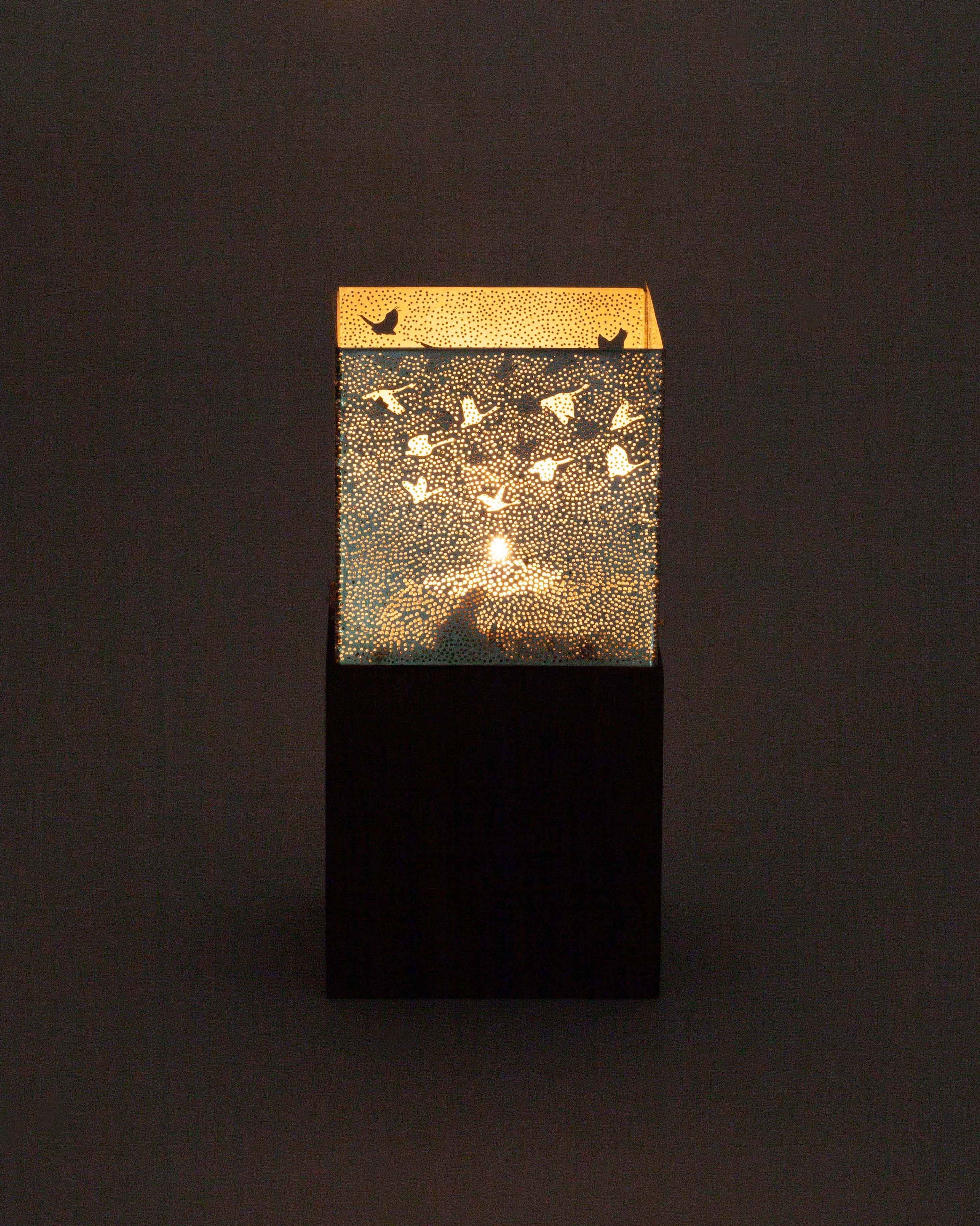 Decorative lamp with a wooden panel featuring bird illustrations on a dark background