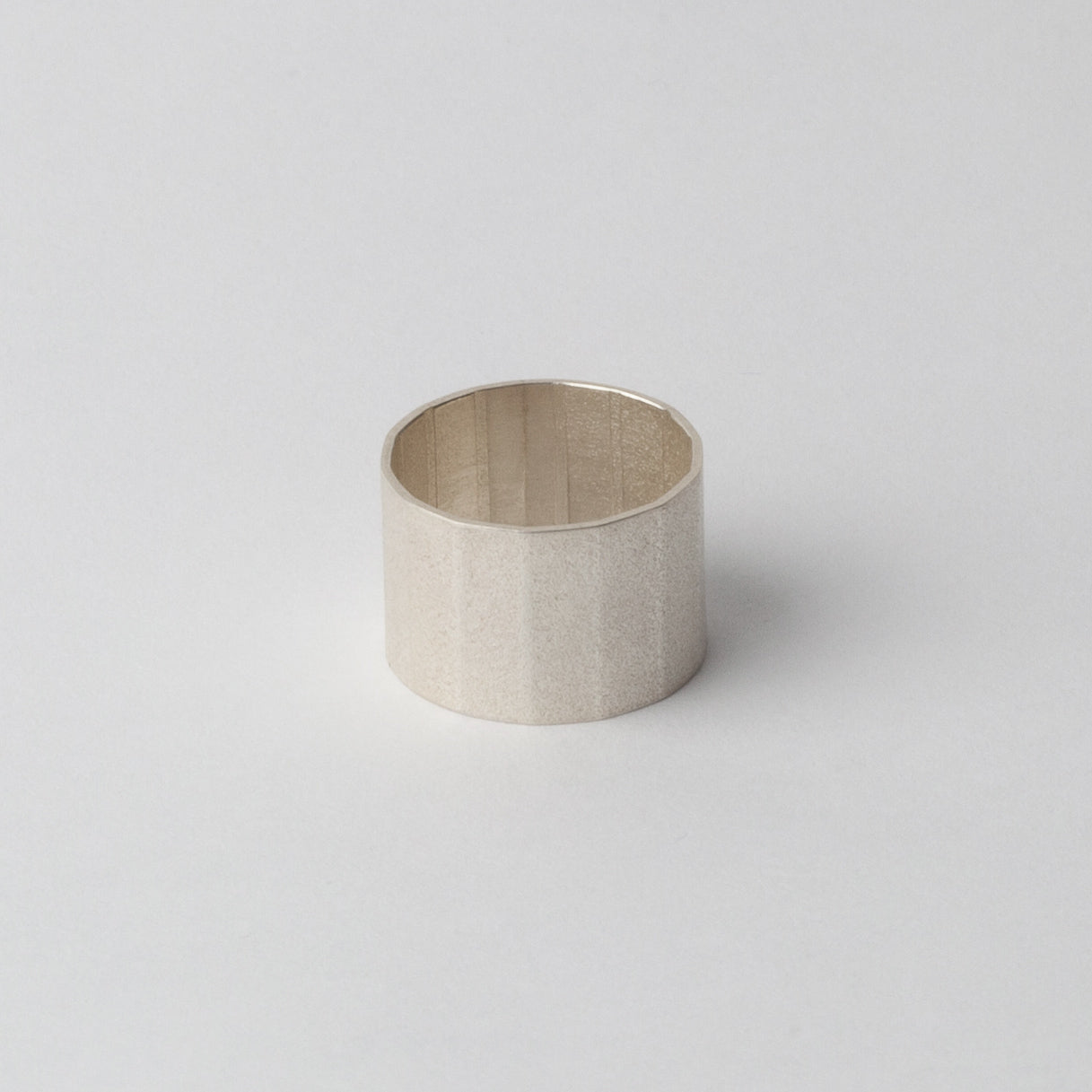 Silver textured ring (faceted band)
