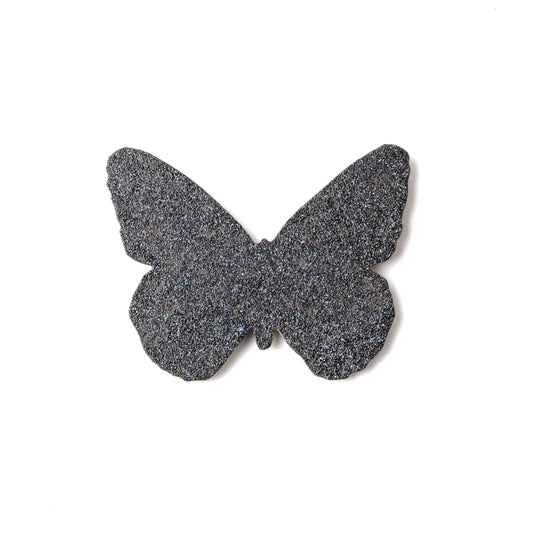 Butterfly-shaped object with a textured surface on a white background