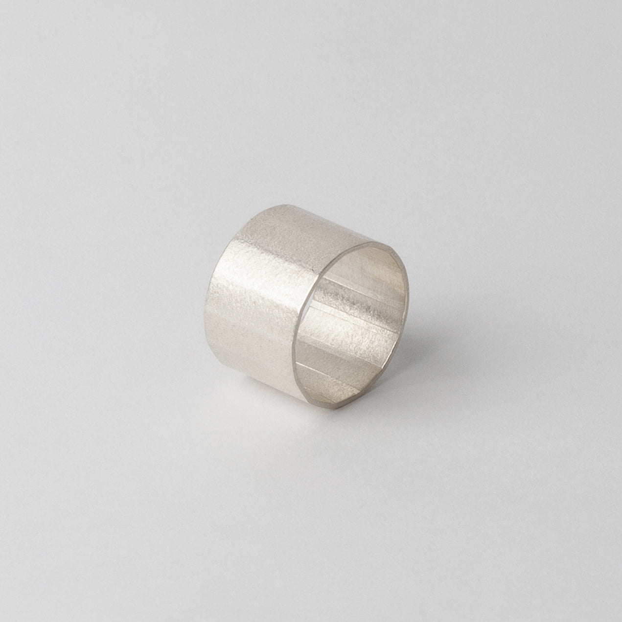 Silver textured ring (faceted band)