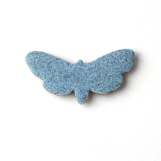 Blue butterfly-shaped object on a white background