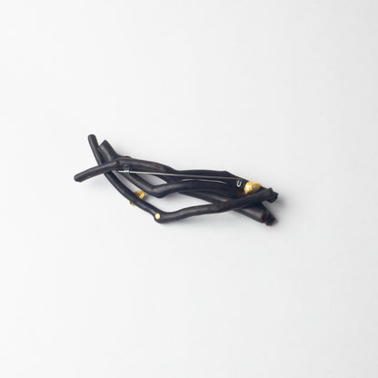 'Burnt stick with gold leaves' brooch